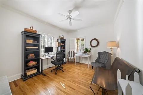 a view of a workspace with furniture and a bookshelf