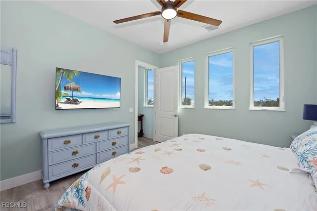 a bedroom with a bed a dresser and a window