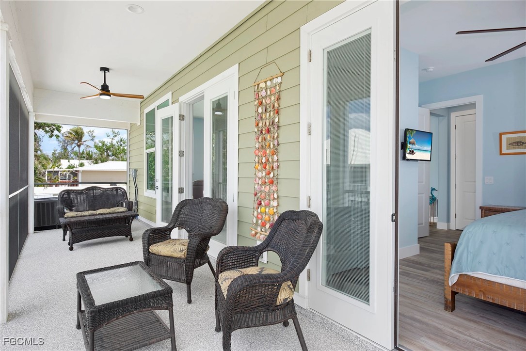 151 Chapel Street Fort Myers Beach, FL 33931 - Photo 12 of 23 a living room with furniture and a large window