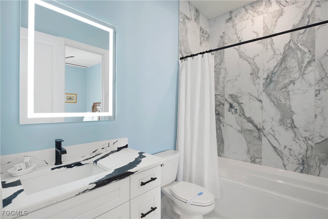 151 Chapel Street Fort Myers Beach, FL 33931 - Photo 15 of 23 a bathroom with a sink and a mirror