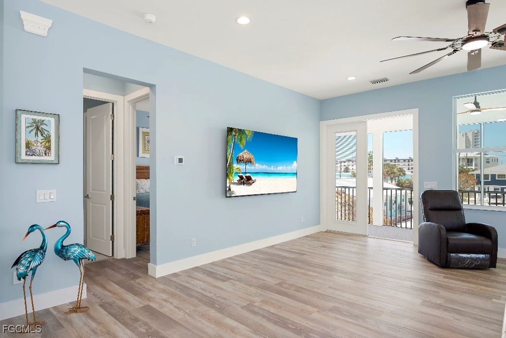 151 Chapel Street Fort Myers Beach, FL 33931 - Photo 18 of 23 a living room with furniture and a wooden floor