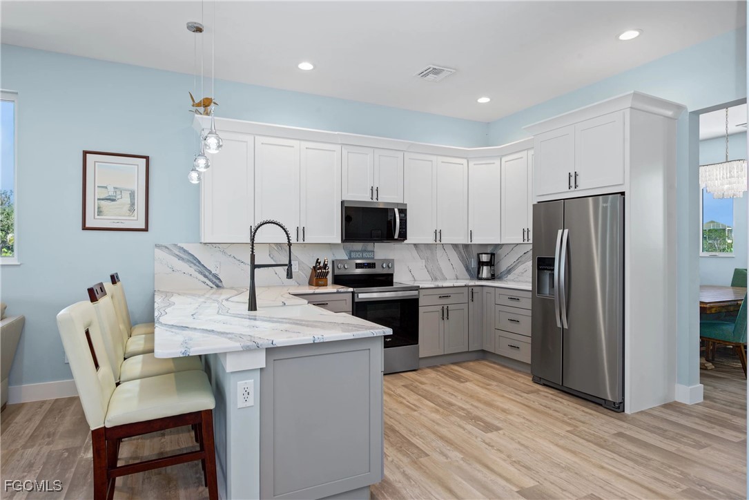 151 Chapel Street Fort Myers Beach, FL 33931 - Photo 19 of 23 a kitchen with a sink cabinets and refrigerator