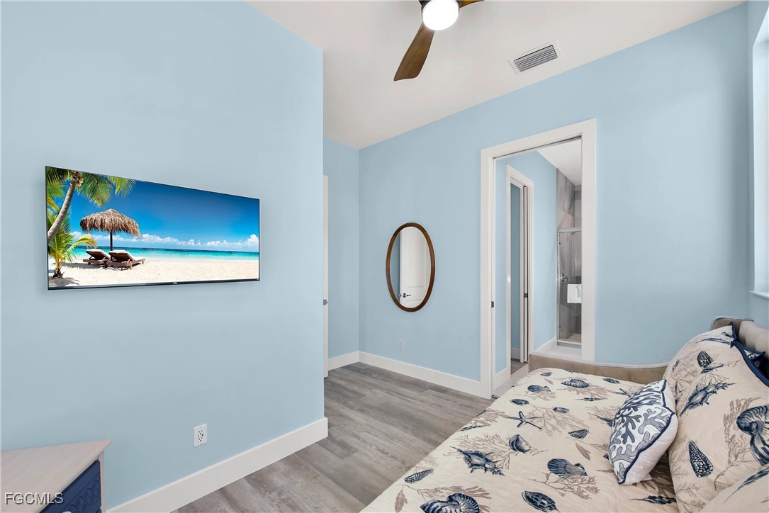 151 Chapel Street Fort Myers Beach, FL 33931 - Photo 20 of 23 a bedroom with a bed and a window