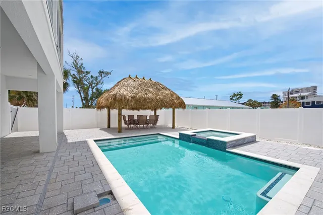 a view of a house with backyard and sitting area