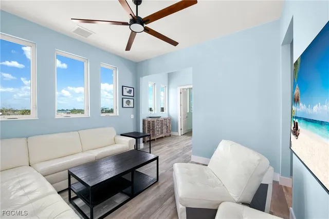 a living room with furniture and a large window