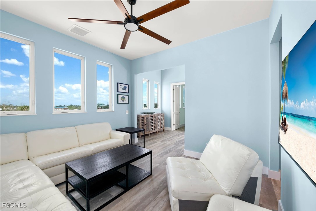 151 Chapel Street Fort Myers Beach, FL 33931 - Photo 7 of 23 a living room with furniture and a large window