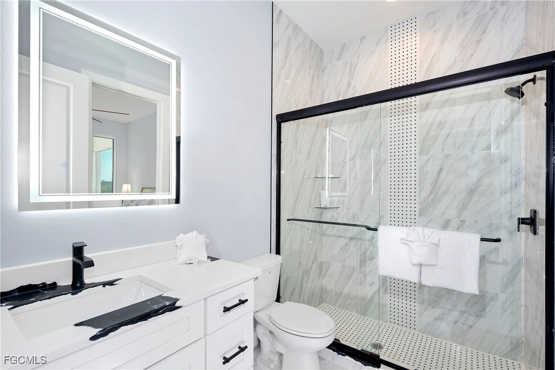 151 Chapel Street Fort Myers Beach, FL 33931 - Photo 10 of 23 a bathroom with a sink toilet and shower