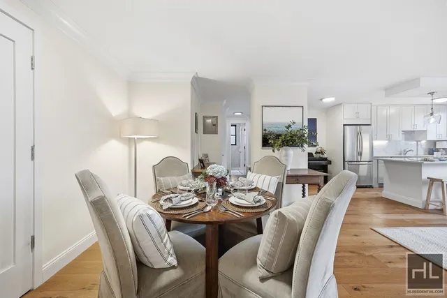 a dining room with furniture a rug and a kitchen
