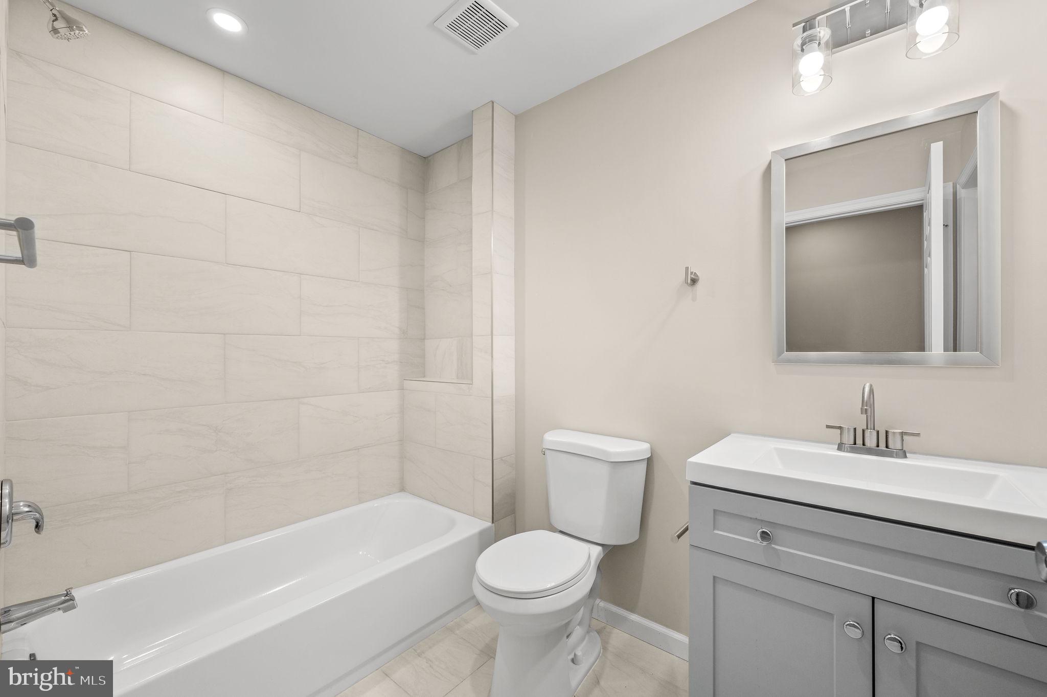 2134 North 19th Street, Unit 1 Philadelphia, PA 19121 - Photo 5 of 10 a bathroom with a sink a toilet and shower