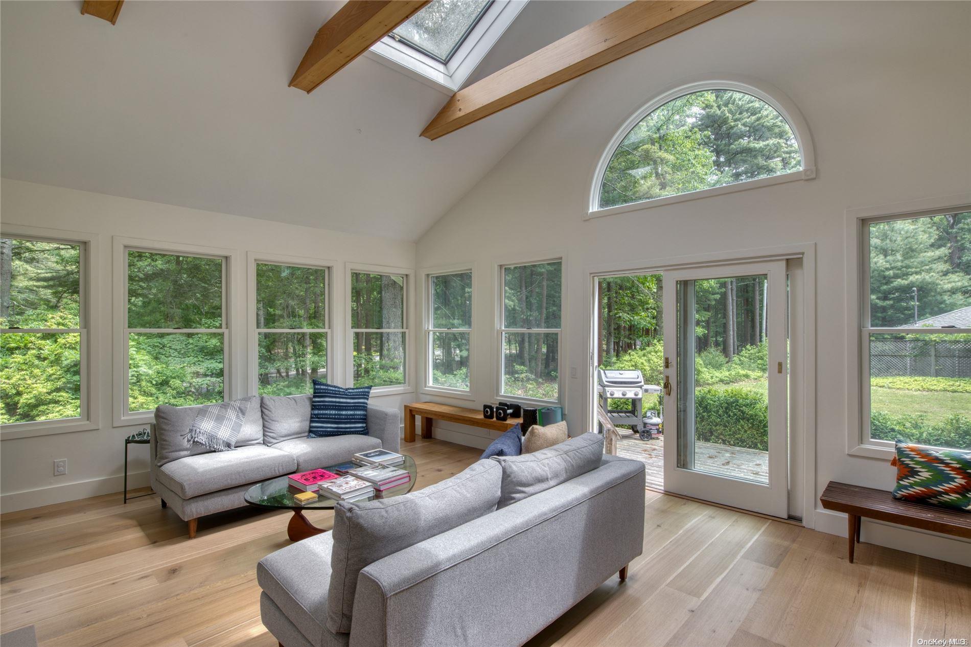 1425 Paradise Point Road Southold, NY 11971 - Photo 1 of 1 a living room with furniture and a large window