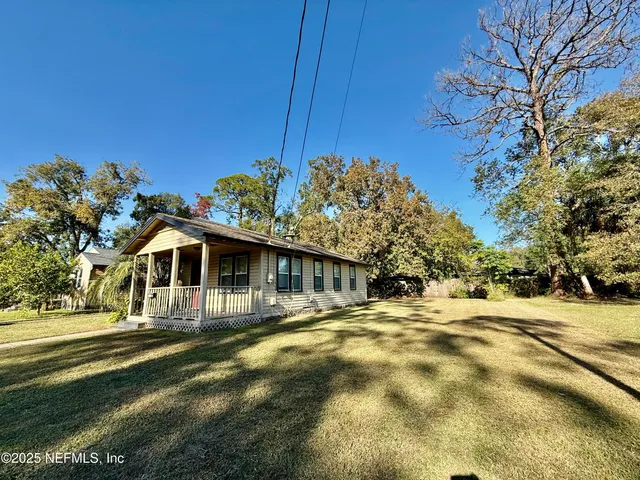 a front view of a house with a big yard