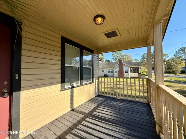 a view of a porch with wooden floor