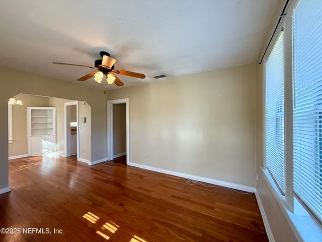 wooden floor in an empty room with a window