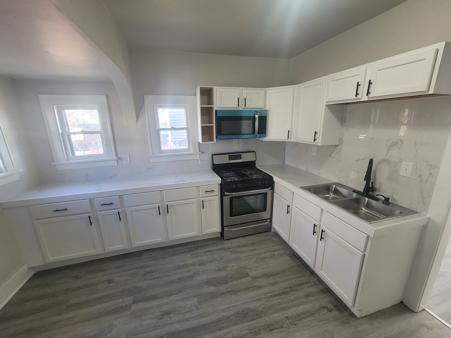 550 5th Avenue Aurora, IL 60505 - Photo 2 of 10 a kitchen with granite countertop white cabinets and white appliances
