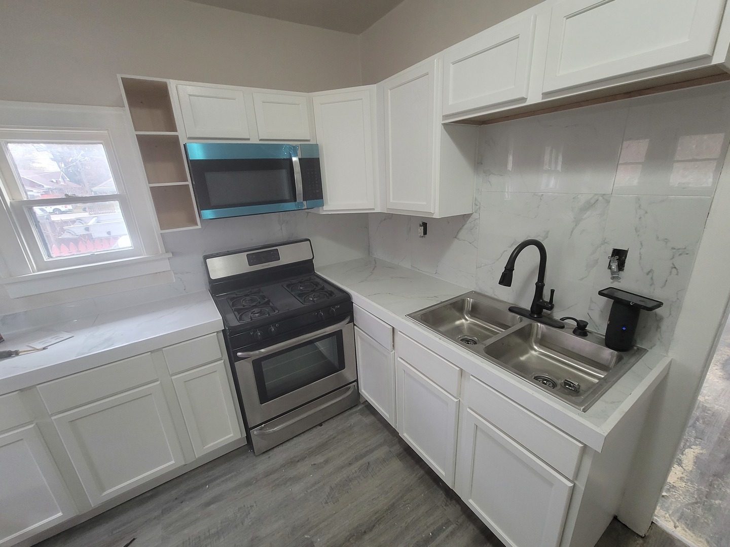 550 5th Avenue Aurora, IL 60505 - Photo 3 of 10 a kitchen with a sink and a stove top oven