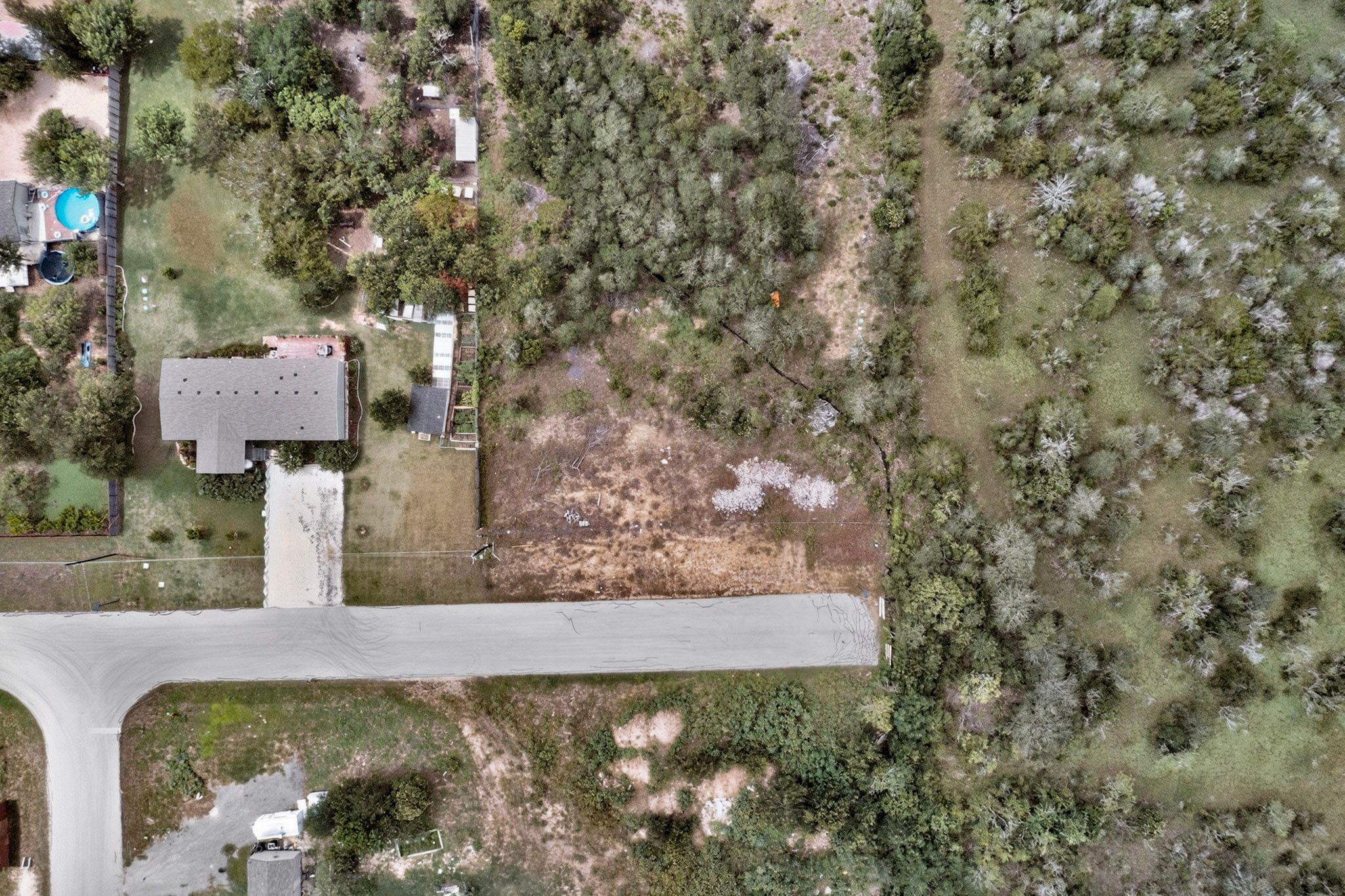 693 Santa Teresa Road Kyle, TX 78640 - Photo 3 of 20 An aerial perspective reveals the expansive lot and surrounding natural landscape.