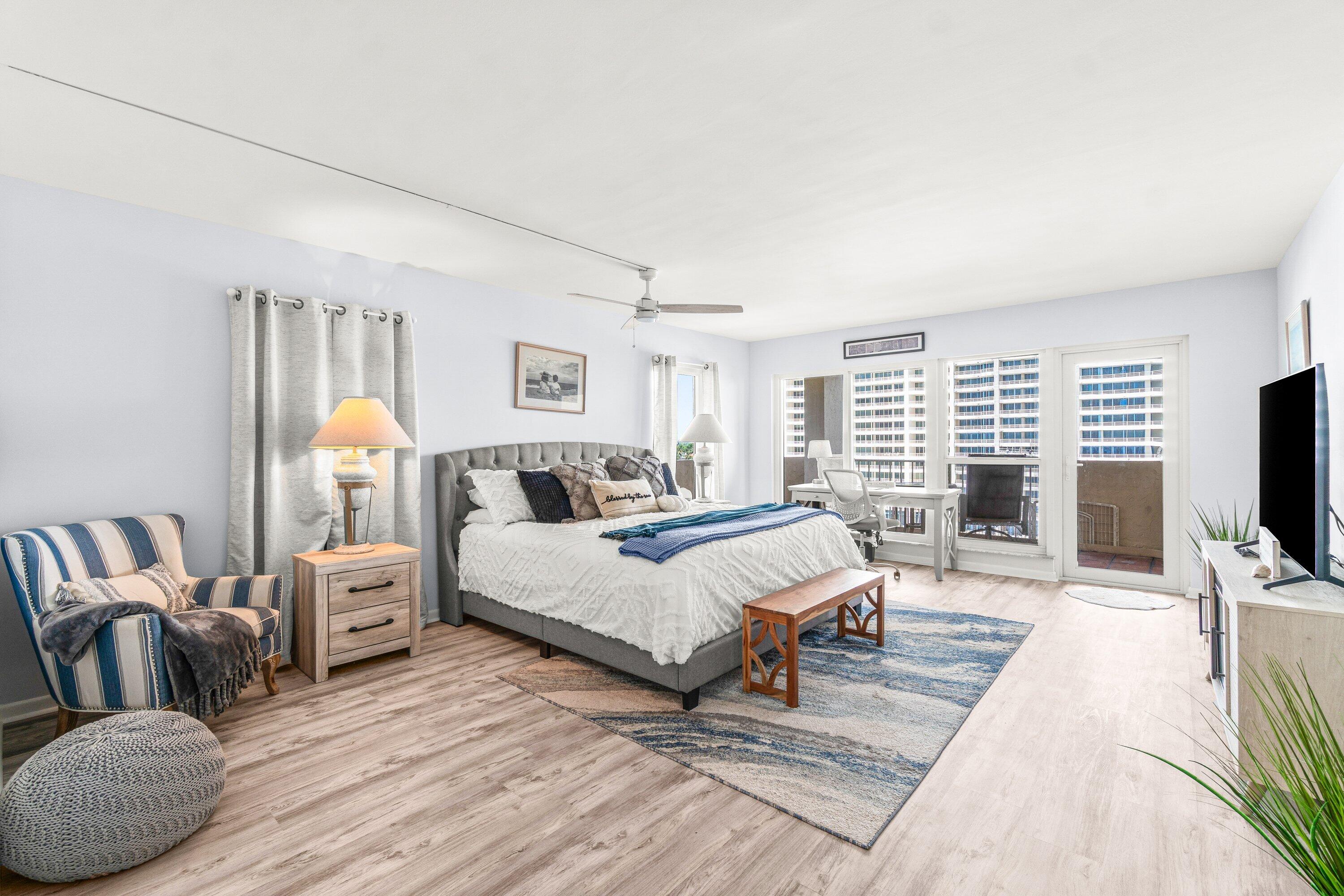 4301 North Ocean Boulevard, Unit 708 Boca Raton, FL 33431 - Photo 27 of 51 a spacious bedroom with a bed and a flat screen tv