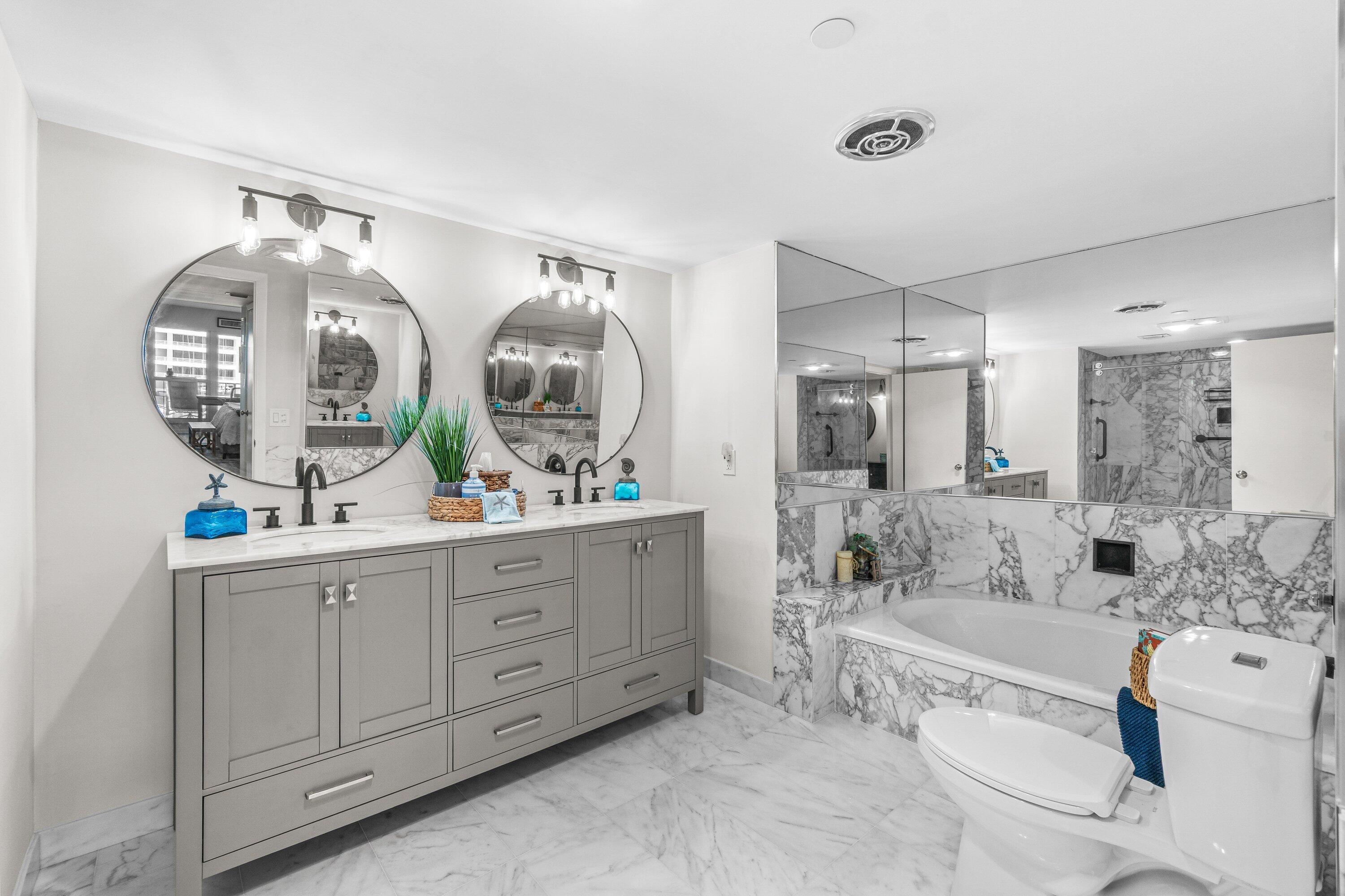 4301 North Ocean Boulevard, Unit 708 Boca Raton, FL 33431 - Photo 31 of 51 a spacious bathroom with a double vanity sink mirror and bathtub