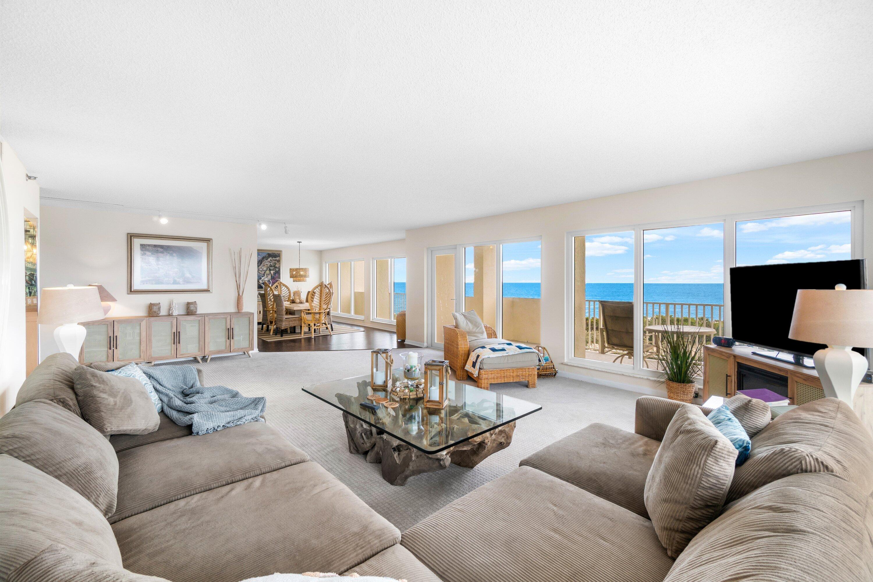 4301 North Ocean Boulevard, Unit 708 Boca Raton, FL 33431 - Photo 4 of 51 a living room with furniture and a flat screen tv