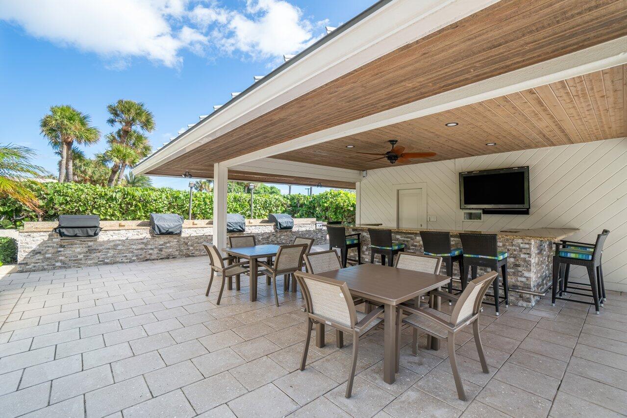 4301 North Ocean Boulevard, Unit 708 Boca Raton, FL 33431 - Photo 45 of 51 a view of a patio with a table and chairs