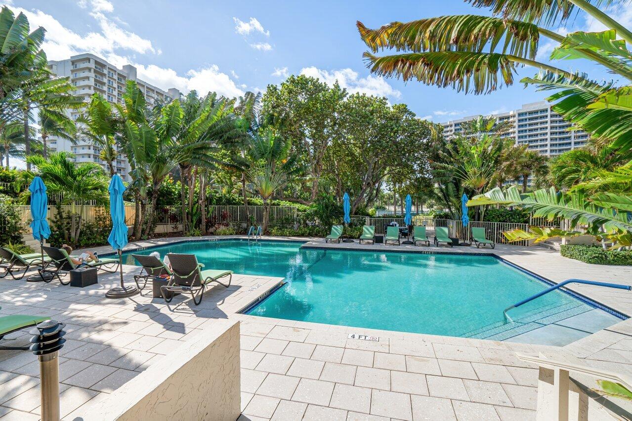4301 North Ocean Boulevard, Unit 708 Boca Raton, FL 33431 - Photo 46 of 51 a view of a swimming pool with a table and chairs