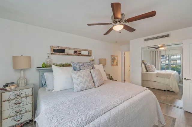 a bedroom with a bed and a ceiling fan