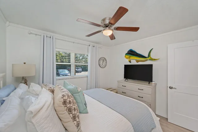 a bedroom with a bed and a tv