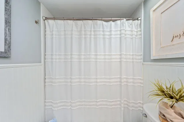 a bathroom with a shower curtain