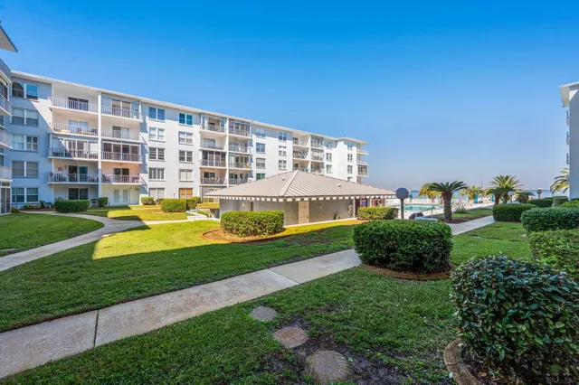 a balcony with wooden floor and stairs
