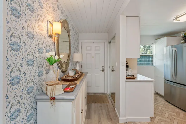 a room with a refrigerator and a sink