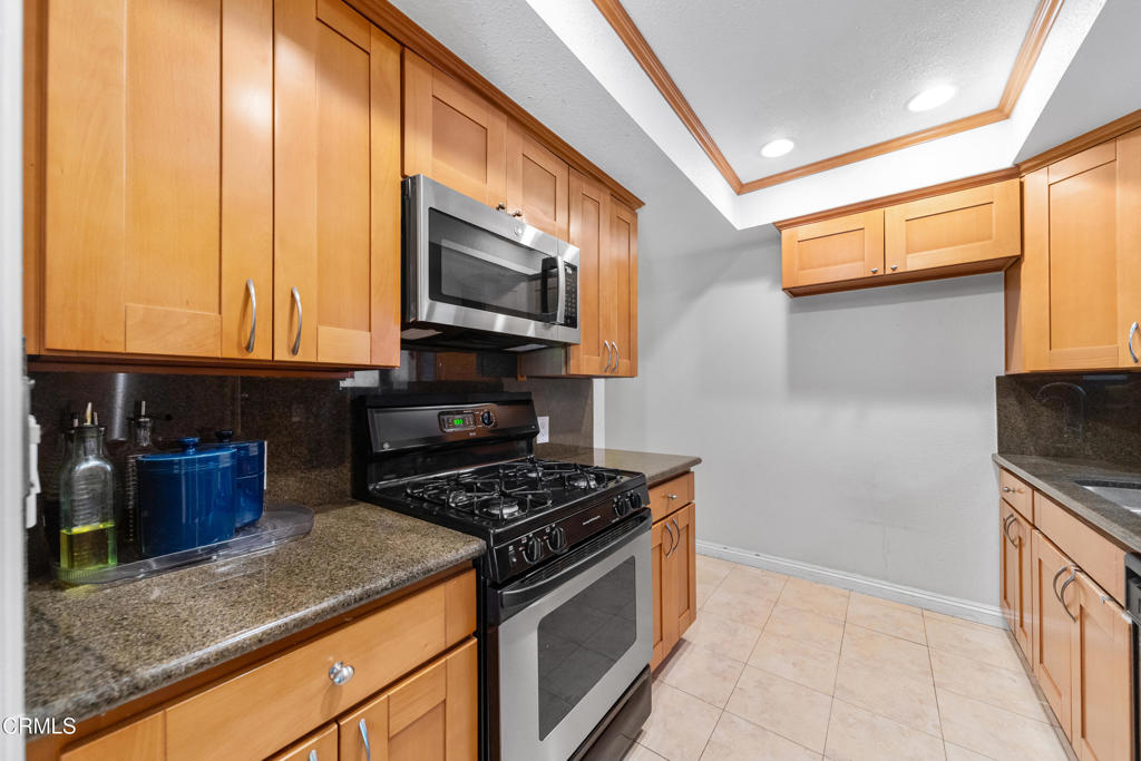 832 Magnolia Avenue, Unit 2 Pasadena, CA 91106 - Photo 12 of 20 a kitchen with stainless steel appliances granite countertop a stove a sink and a microwave