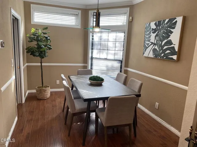 a living room with furniture a fireplace and a floor to ceiling window