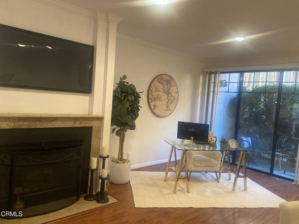 832 Magnolia Avenue, Unit 2 Pasadena, CA 91106 - Photo 7 of 20 a living room with furniture a fireplace and a floor to ceiling window