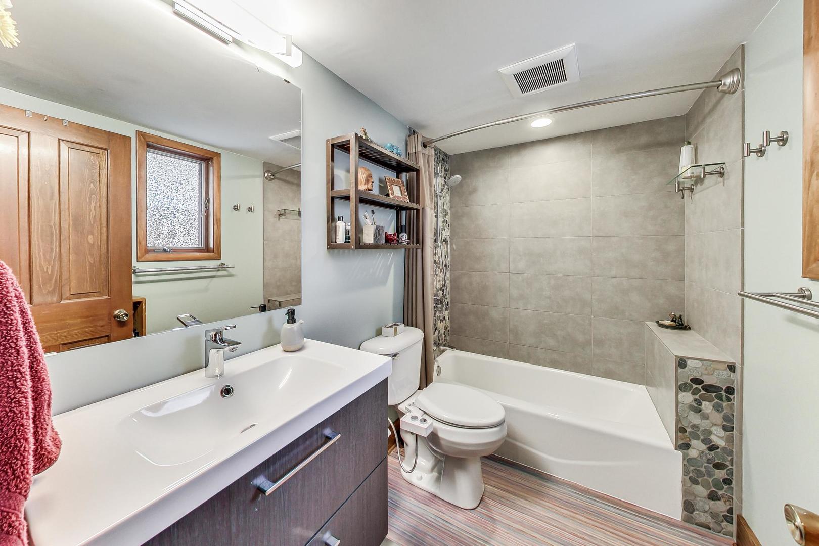 208 Waubansee Road Riverside, IL 60546 - Photo 18 of 38 a bathroom with a sink toilet and shower