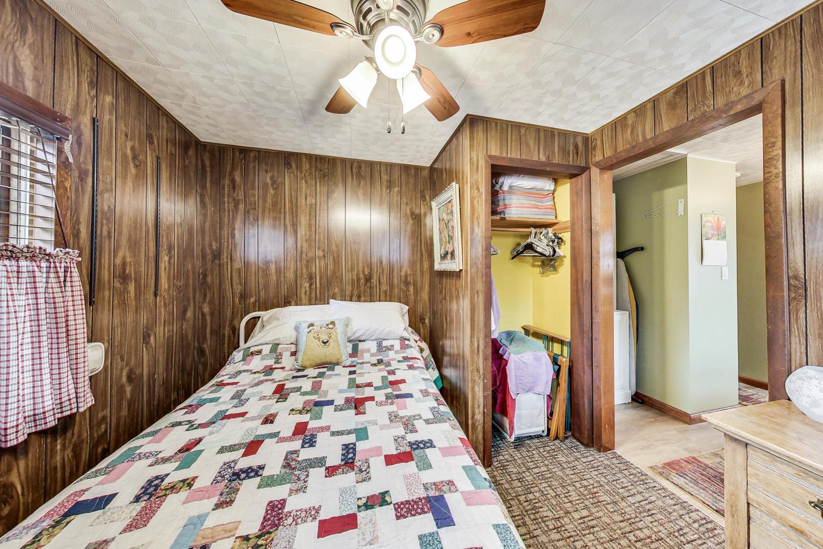 208 Waubansee Road Riverside, IL 60546 - Photo 25 of 38 a bedroom with a bed and a chandelier