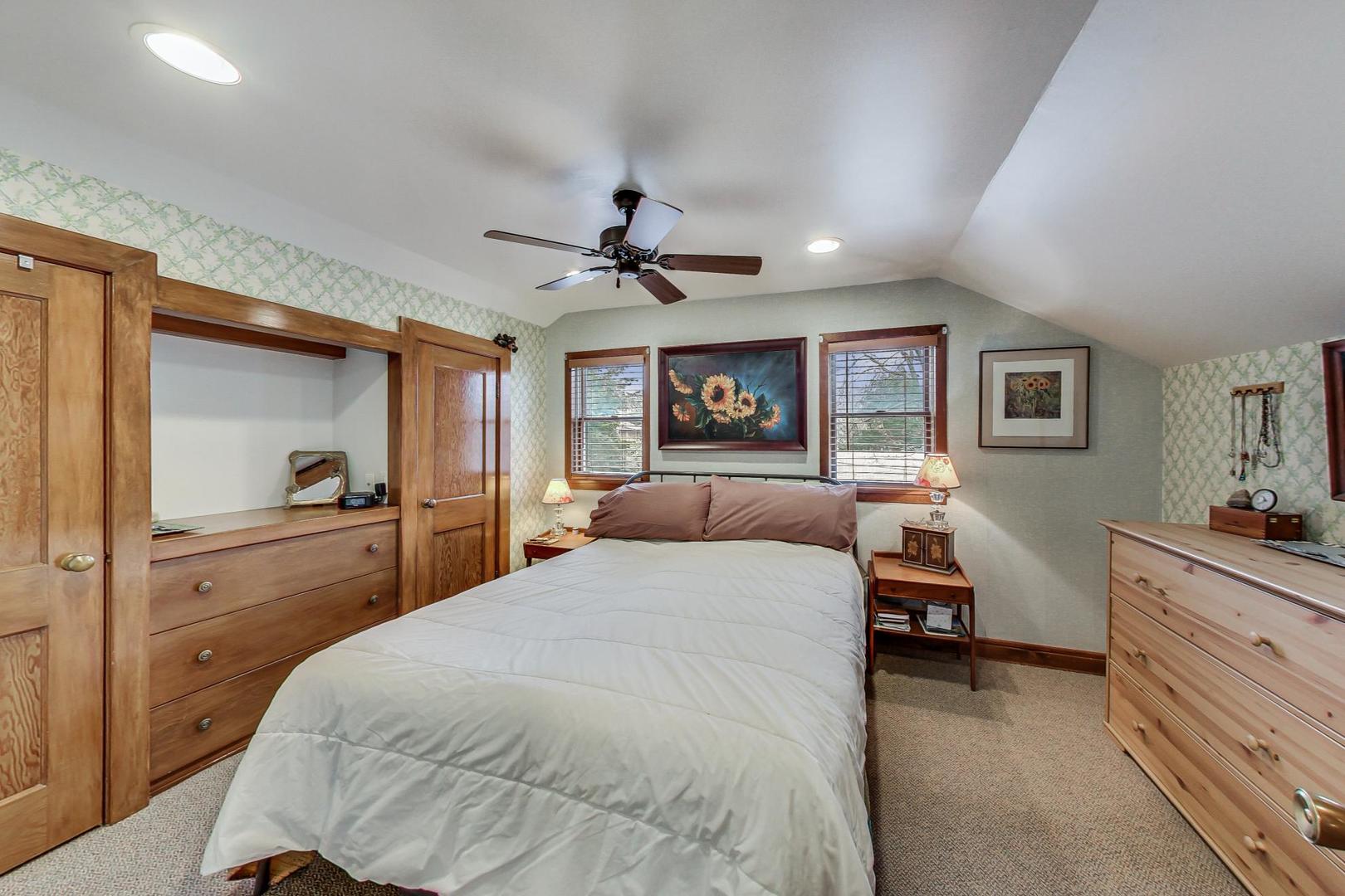 208 Waubansee Road Riverside, IL 60546 - Photo 26 of 38 a bedroom with a large bed and a chandelier