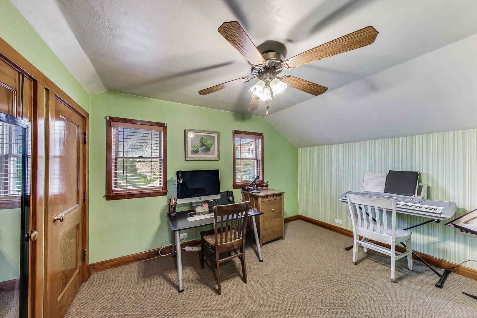 208 Waubansee Road Riverside, IL 60546 - Photo 28 of 38 a workspace with chandelier fan and a window