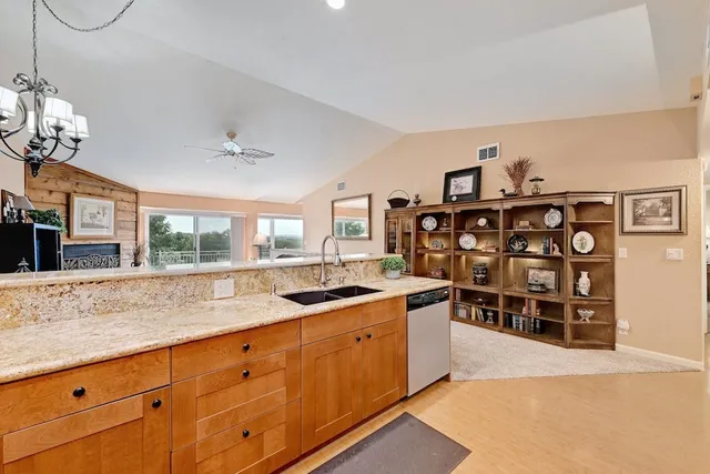 a kitchen with stainless steel appliances granite countertop a sink and a counter space