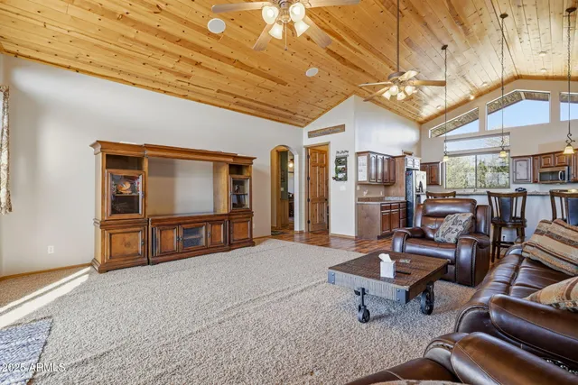a living room with patio furniture and a flat screen tv