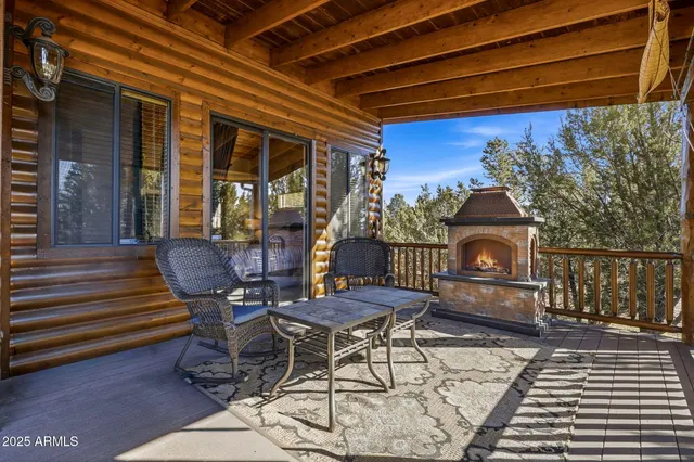 a view of a patio with table and chairs with wooden floor and fence
