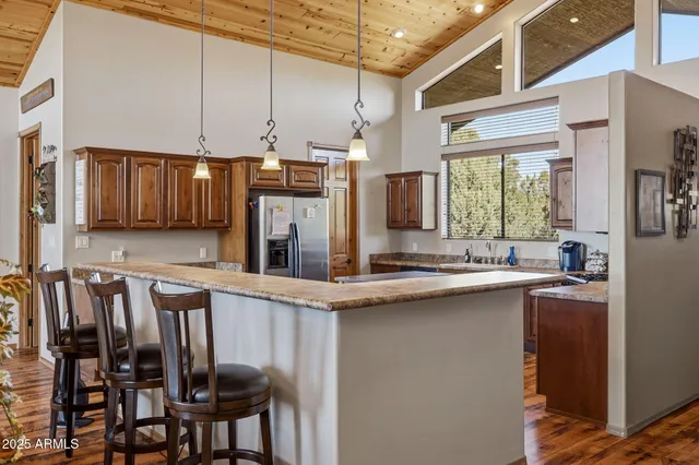 a kitchen with stainless steel appliances a sink stove and cabinets