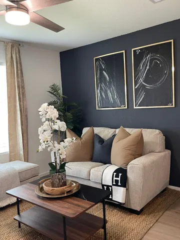 a living room with furniture flowerpot and window