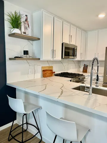 a kitchen with a sink cabinets and window