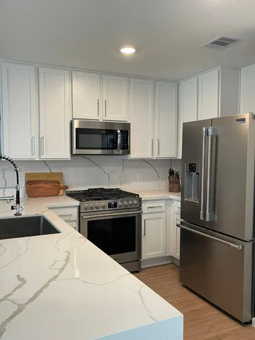 a kitchen with a refrigerator stove and microwave
