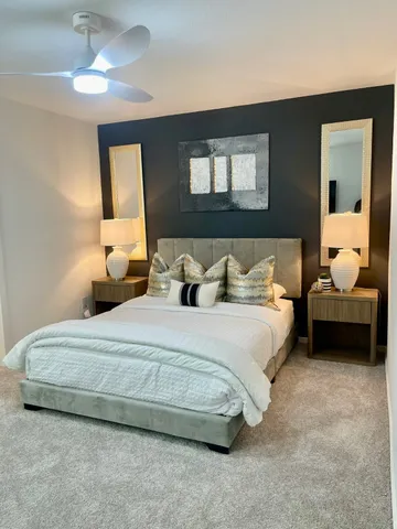 a bedroom with bed and a chandelier