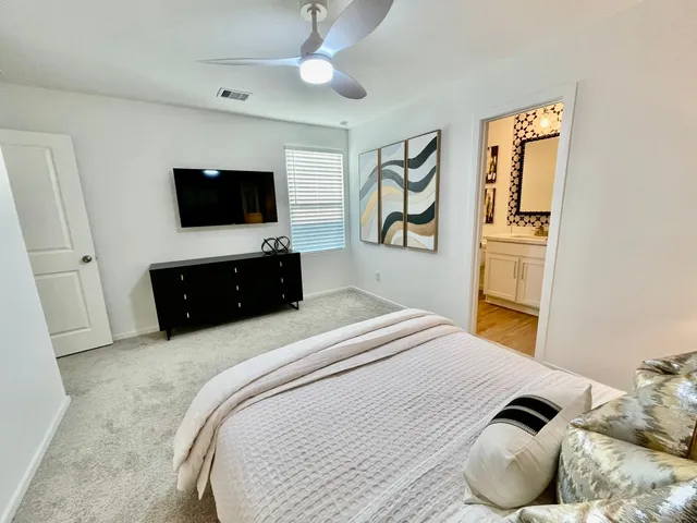 a bedroom with a bed and a flat screen tv