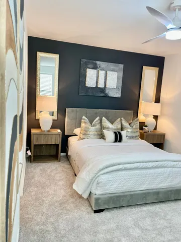 a bedroom with bed and a mirror