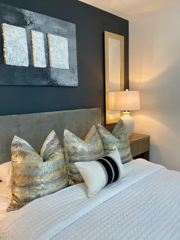 a bed sitting in a bedroom next to a window