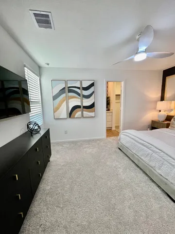 a bedroom with a bed and a flat screen tv