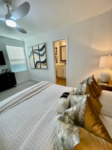 a bedroom with a bed and a chandelier